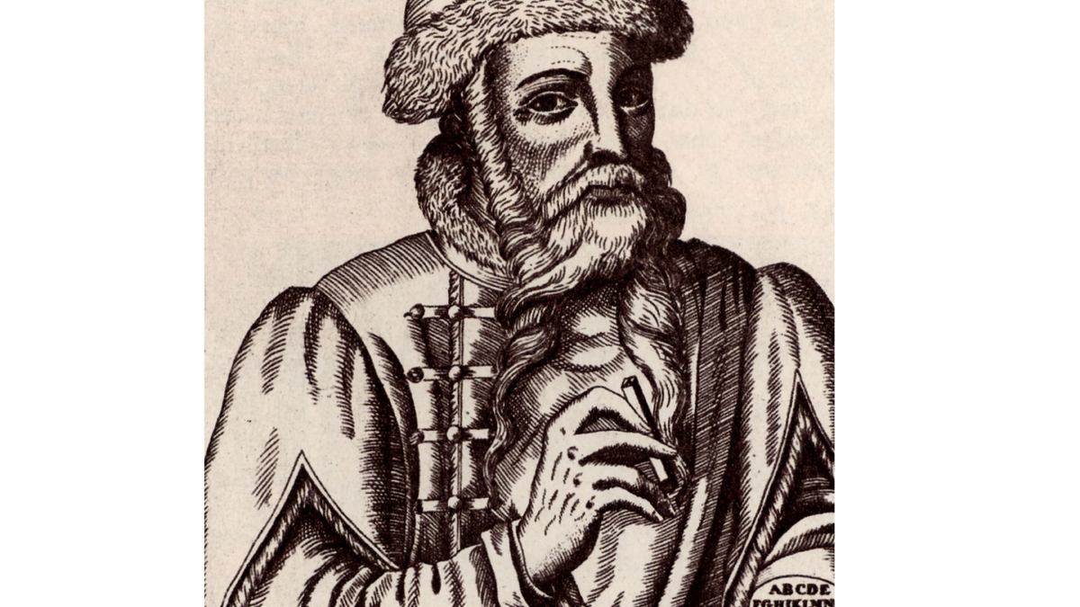 Bearded man in Renaissance robes and fur hat. 