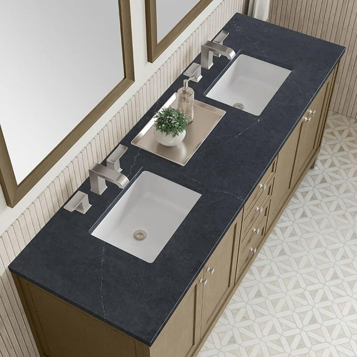 Vanity with dark stone countertop. 