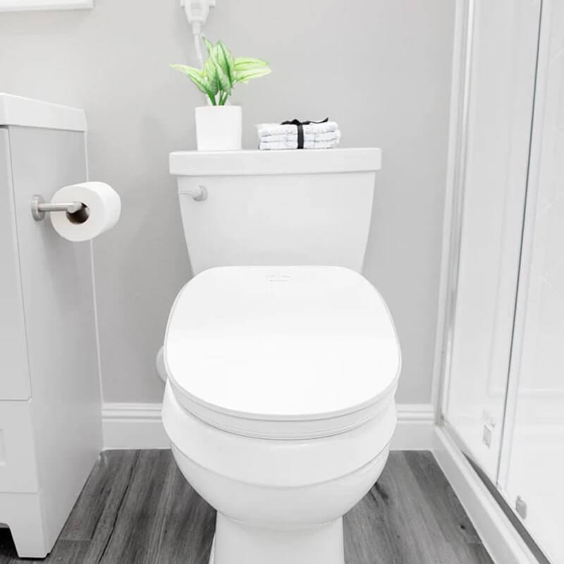Bright modern bathroom with toilet and shower.
