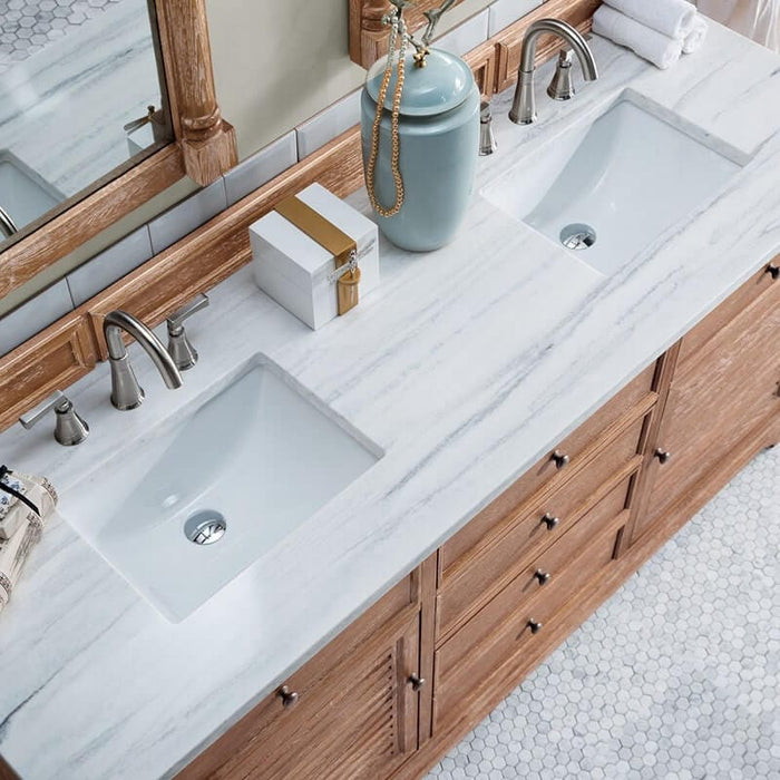 Double sink wood vanity with white marble countertop. 