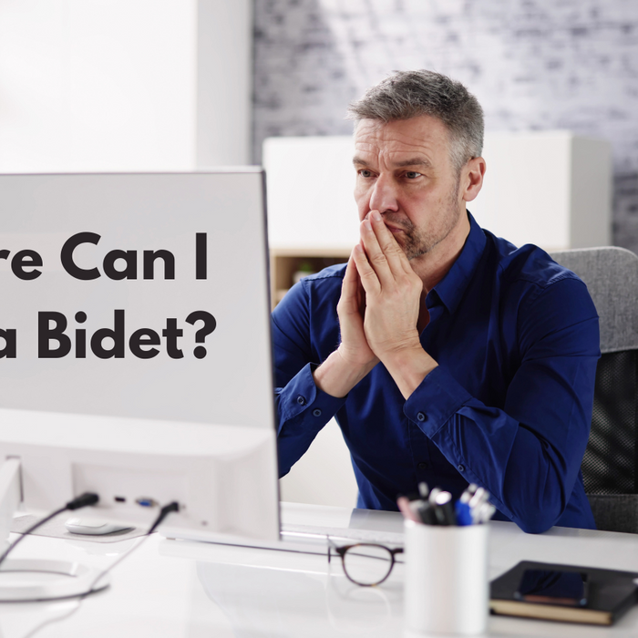 man in front of computer, trying to find the best place to buy a bidet online