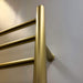 Radiant Straight Towel Warmer Satin Brass Close-Up View Wall-Mounted