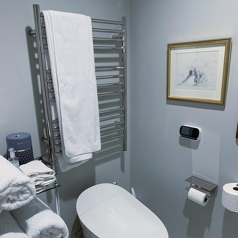 Amba Jeeves Model C Straight 13 Bar Hardwired Towel Warmer in Polished Stainless Above Toilet