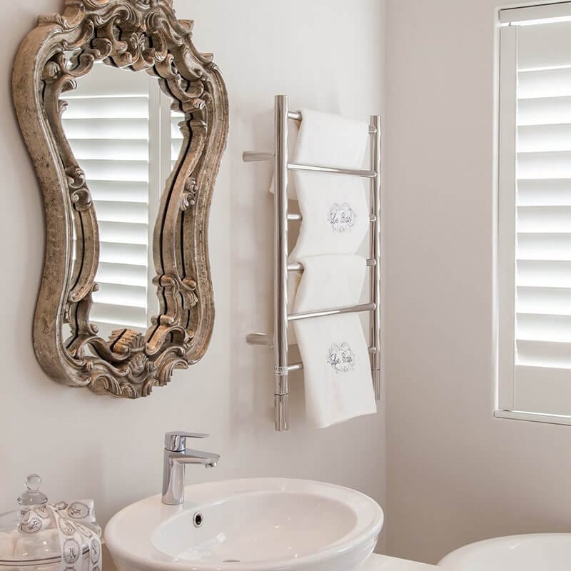 Amba Jeeves Model J Straight 6 Bar Hardwired Drying Rack in Polished Stainless Beside Vanity