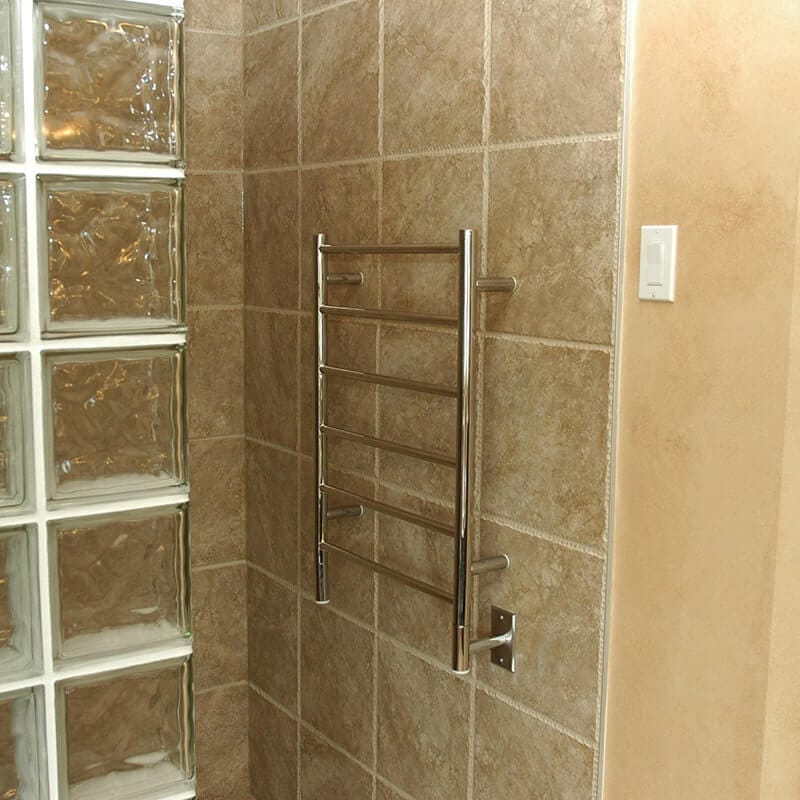 Amba Jeeves Model J Straight in Polished Stainless Mounted to Beige Bathroom Wall