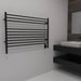 Amba Jeeves Model L Straight 10 Bar Hardwired Towel Warmer in Oil Rubbed Bronze Corner View Beside Vanity