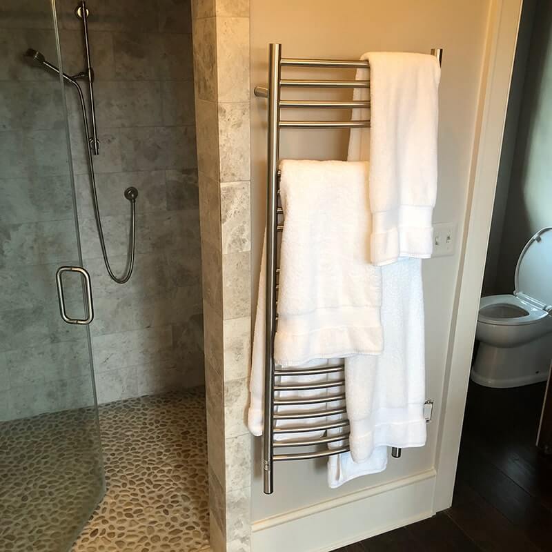Jeeves Model D Curved Towel Warmer in Polished Stainless Mounted Outside Shower Room
