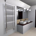 Jeeves Model D Straight 20 Bar Towel Warmer in Polished Stainless Mounted Beside Two Sink Vanity Cabinet