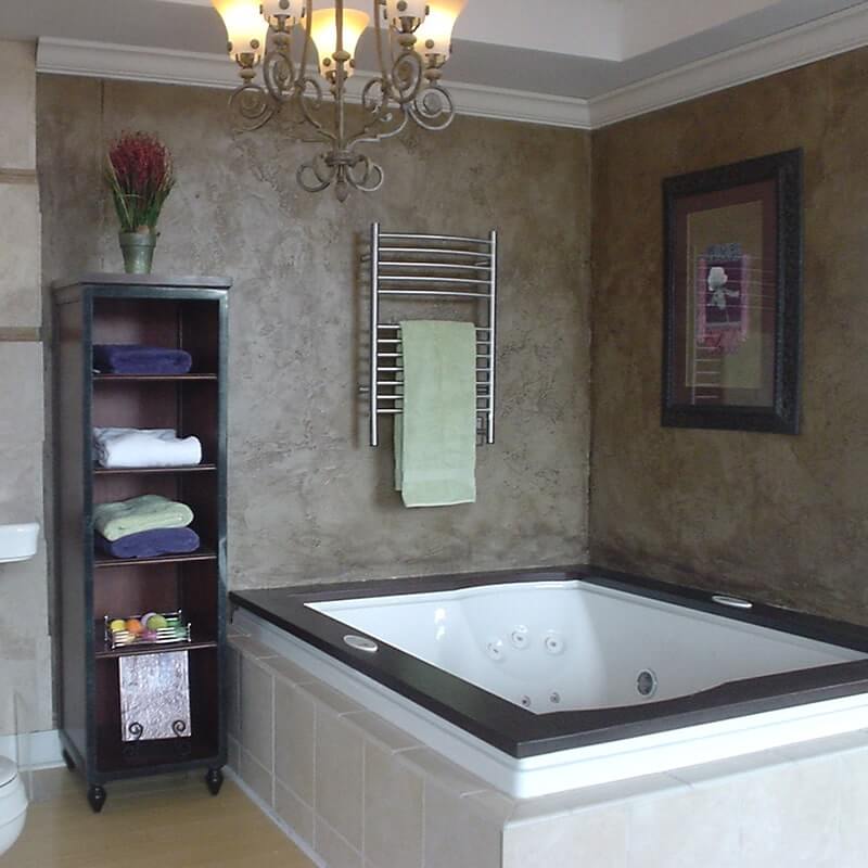 Jeeves Model E Curved Towel Warmer in Brushed Stainless Corner View Lifestyle With Green Towel