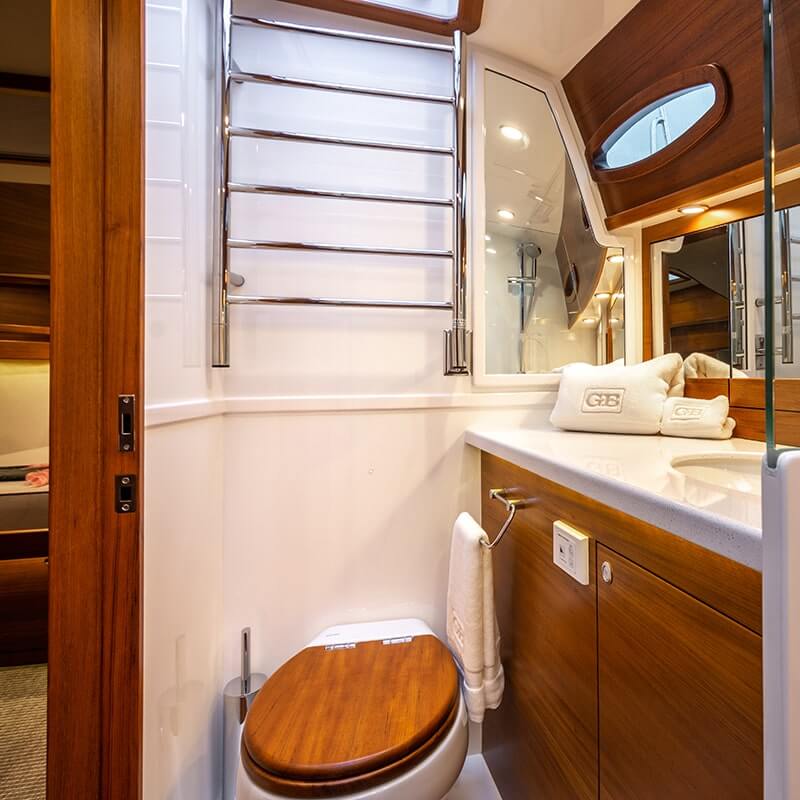 Jeeves Model J Straight Drying Rack in Polished Stainless Mounted on Top of a Toilet