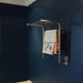 Jeeves Model M Shelf Towel Warmer in Polished Stainless Mounted on Blue Wall