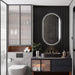Lexi oval LED mirror installed above a black vessel sink in a modern dark-toned bathroom vanity