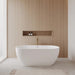 Wyndham Collection Juno 63" Freestanding Acrylic Matte White Bathtub With Shiny White Trim and Brushed Gold Faucet Lifestyle
